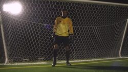 A goalie places his feet in position while standing in front of the net. Stock Footage