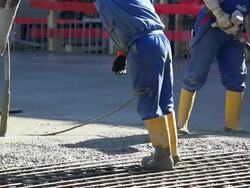 MS Workers Directing Concrete Onto The Construction Site Stock Footage