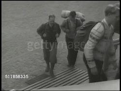 1943: NORWEGIAN REFUGEES: Women, men w/ rolled backpacks walking on rural road from Norway, walking up building steps. FREE FRENCH OFFICES: Office w/ elder male speaking to two typists. WS EXT Free French offices. Free French delegation reception line Instructional Video