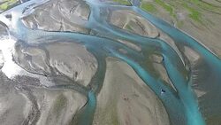 Aerial long shot of a Brown Bear walking up a river looking for fish Stock Footage