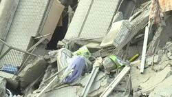 CLEAN : Taiwan rescuers remove body from quake collapse site News Clip