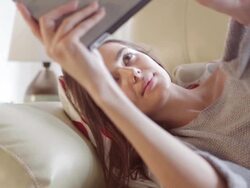 Tablet lying on sofa.    CM Stock Footage