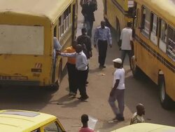 MS ZI Shot of man directing yellow buses and taxis near market / Lagos, Nigeria Stock Footage