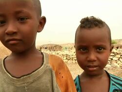 Children looking at camera and man calming down small child Stock Footage