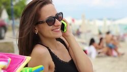 Loving woman talking on cellphone on beach Stock Footage