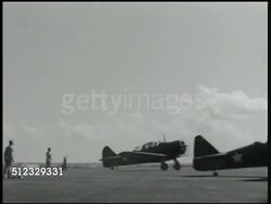 1941: U.S. MARINE BASE: NAVY AIR FORCE: WS US Fighter airplanes (variation Curtiss P-36 Hawk) taxiing. LA VS Airplanes taking off, flying by pole w/ US flag. XLA WS Airplanes flying formation. MS Explosion near flags. Philippines, Pacific Front, WWII Instructional Video