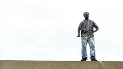 MS LA Man dancing along rooftop wall Stock Footage