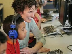 MS TU Students wearing headphones sitting in computer lab with teacher / Richmond, Virginia, United States  Stock Footage