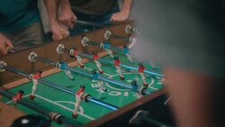 Guys playing tabletop soccer in apartment Stock Footage