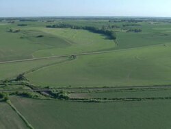 Farm fields and houses with a gravel road Stock Footage