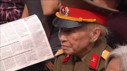 Mourners gather to watch funeral of General Giap on large screen News Clip