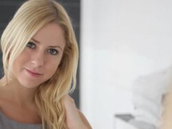 Female in bathroom looking at mirror Stock Footage