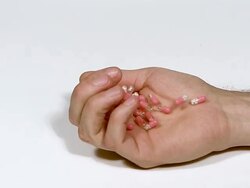 MS SLO MO Mans hand Falling with Capsules of Morphine / Vieux Pont, Normandy, France Stock Footage