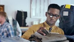 Clothing shop worker counts products and takes stock of store inventory with tablet Stock Footage