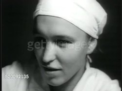 1935: MOSCOW, USSR, SOVIET UNION: State Day Nursery, toddler carrying food plate to table, CU Nurse, Nurse feeing babies at table, child w/ no eye motor control (very young) sneezing, smiling after taking food. Russia, Communism, lifestyle. Instructional Video