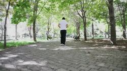 Young Man Running In The Forest Stock Footage