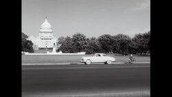 WS View of Capitol Building, cars moving in foreground / Washington DC, United States Stock Footage
