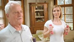 SLO MO senior man exercising with nurse supervision Stock Footage