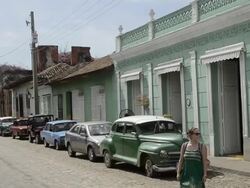 Trinidad Cuba life on the main cobblestone street with colorful buildings and people Stock Footage