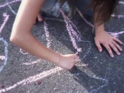 MS TU Little girls running, jumping and playing and one girlis drawing hopscotch  on sidewalk / Langley, British Columbia, Canada.  Stock Footage