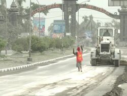 Heavy machinery is used to clear road of ash after eruption of Merapi volcano; Indonesia. 7 November 2010 / AUDIO Stock Footage