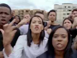 Slow motion medium shot angry crowd glowering and shaking fists at camera Stock Footage