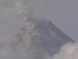 Ash and smoke rise from top of Mayon volcano's summit, Philippines, Dec 2009 Stock Footage