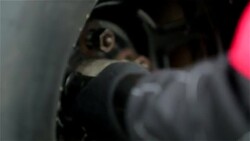 Pit-crewman tightens new race-car tire lug-nuts Stock Footage