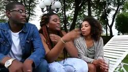 MS Friends hanging out in backyard on summer evening Stock Footage