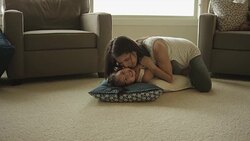 Pregnant ethnic mother playing with her toddler in the living room Stock Footage