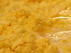 Orange cheese curds in a large mixing tank Stock Footage