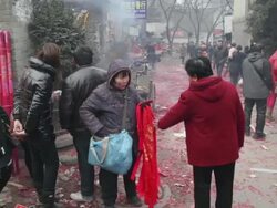 WS Woman selling red prayer flags in front of temple during Chinese Lunar New Year / xi'an, shaanxi, china Stock Footage