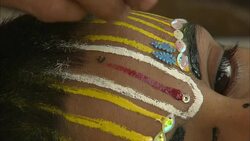 A makeup artist applies jewels over face paint. Stock Footage