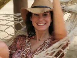 Good looking young Woman in a Hammock, smiles at camera Stock Footage