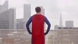 Superhero viewing city from rooftop Stock Footage
