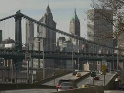 Traffic speeds down the FDR Highway in New York City the Manhattan Bridge and the Downtown Skyline are featured. Stock Footage