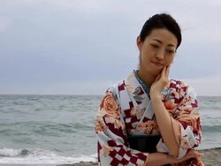 Japanese woman thinking by the sea Stock Footage