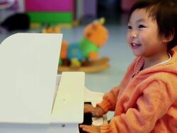 CU Shot of baby girl playing piano / Xian, China Stock Footage