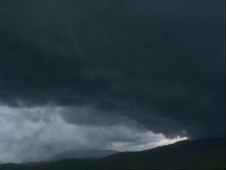 T/L - storm clouds build up over mountain, rain on lens, USA Stock Footage