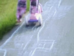 WS Girl playing on scooter and scooting along hopscotch with two girls in background / Langley, British Columbia, Canada.  Stock Footage