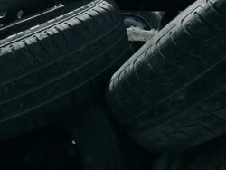 Old used car tires heap at junkyard Stock Footage