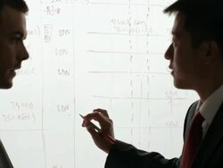 MS Two businessmen discussing and writing on white board / China Stock Footage