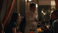 Waitress takes menus from dining couple in upscale restaurant Stock Footage