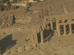 High Angle, aerial zoom-out - Sandstone historical ruins with large pillars stand out in the Egyptian Nile Delta Stock Footage