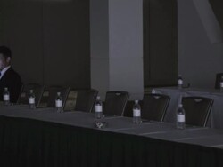  PAN Businessman sitting alone in dark conference room looking down at cell phone / Seattle, Washington, United States Stock Footage