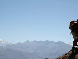 Hiker climbs to mountain overlook, takes pic with smart phone Stock Footage