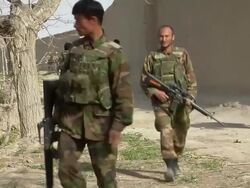WS Group of soldiers walking by wall / Afghanistan. Stock Footage
