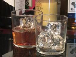 Pouring whiskey over ice into tumblers, Spain Stock Footage