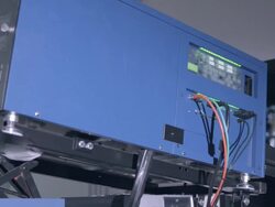 MS PAN across NEC digital cinema projector in projection booth showing 3D movie Stock Footage