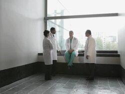 WS Four physicians in informal meeting at hospital corridor / Seattle, Washington, USA Stock Footage